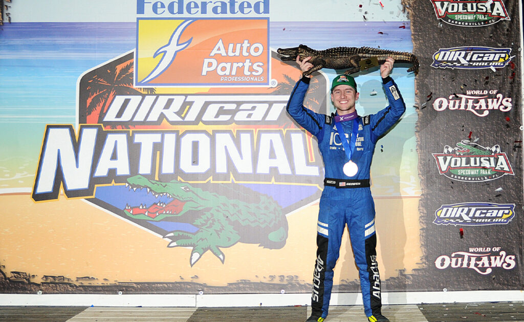 Logan Seavey holding the Big Gator trophy above his head